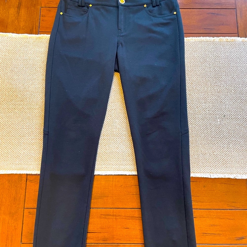 Black pants by Tahari with gold buttons and zippers at the back lower legs.